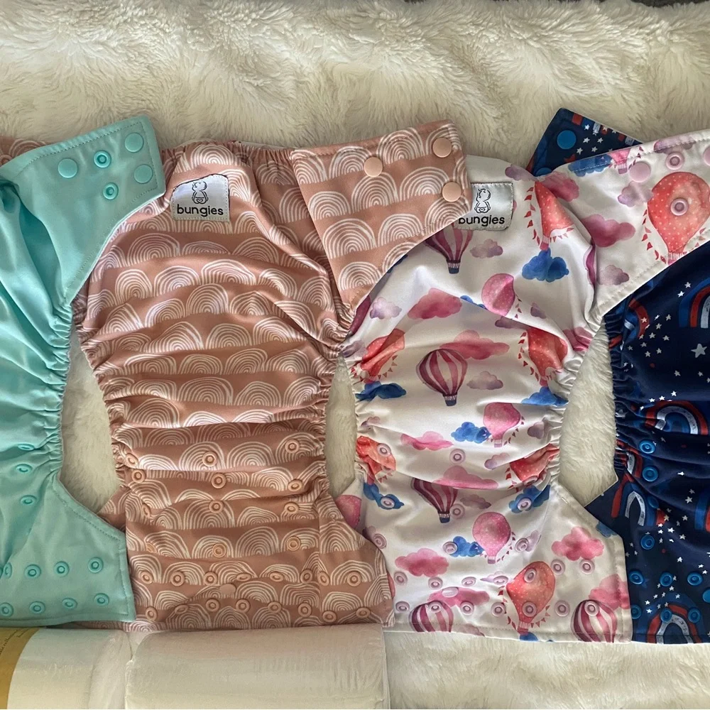 17 pocket cloth diapers + inserts, liners, and storage bags
